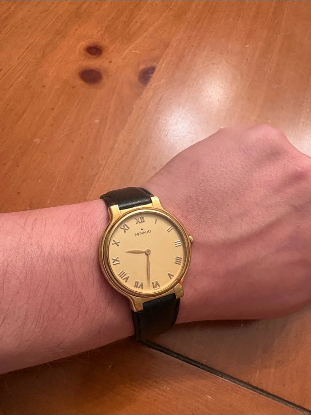Movado Gold Dial Watch with Black Leather Strap